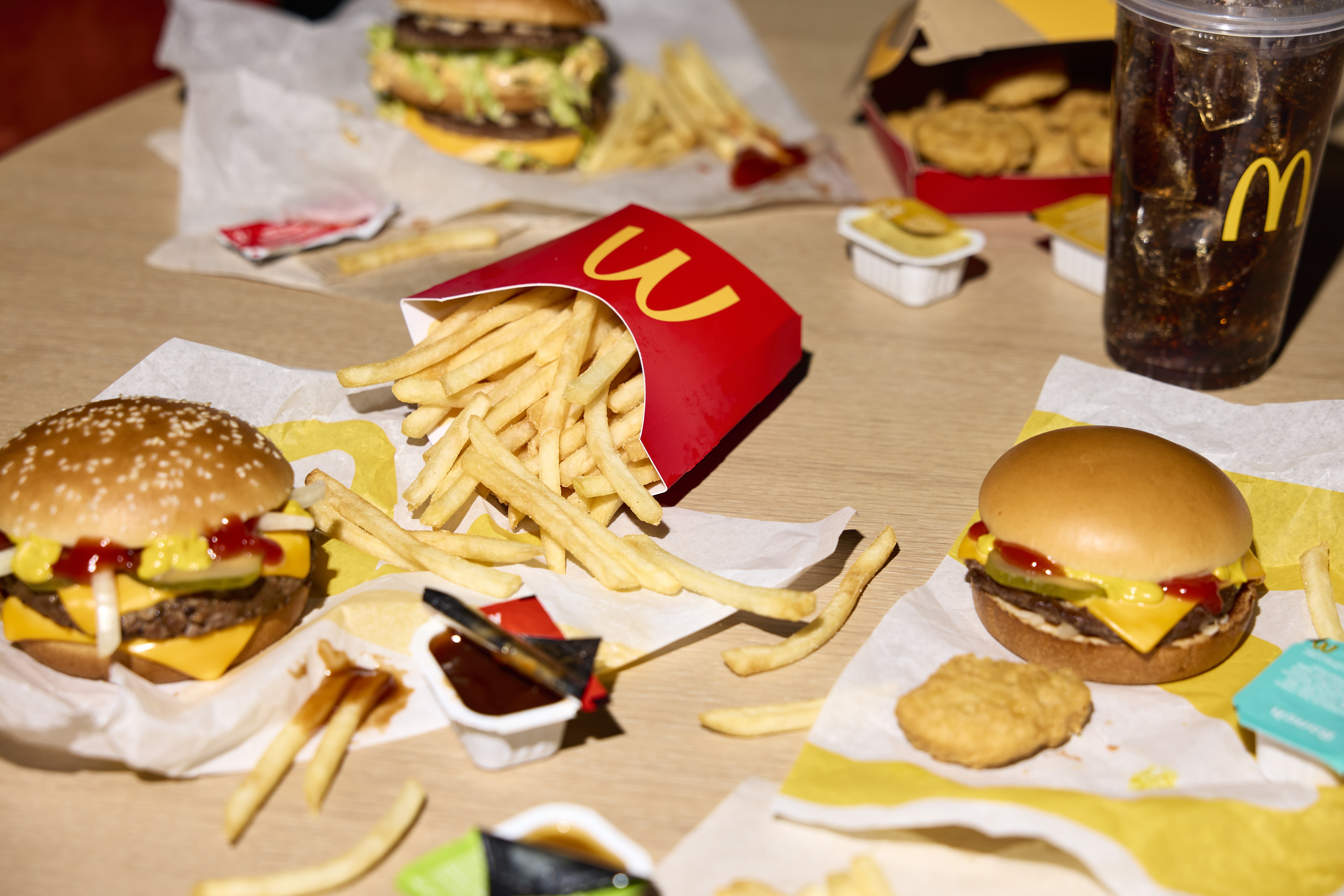 McDonald’s burgers, World Famous Fries and sauces spread out on a table
