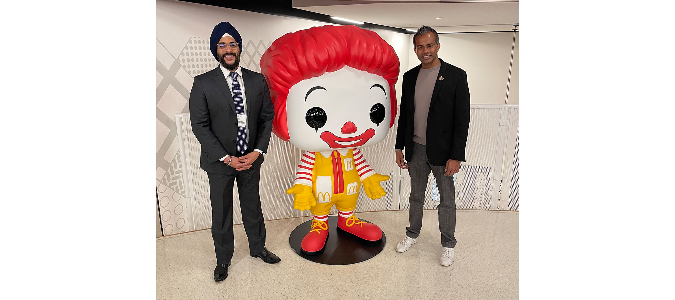 Abiman and Nick next to a Ronald McDonald statue