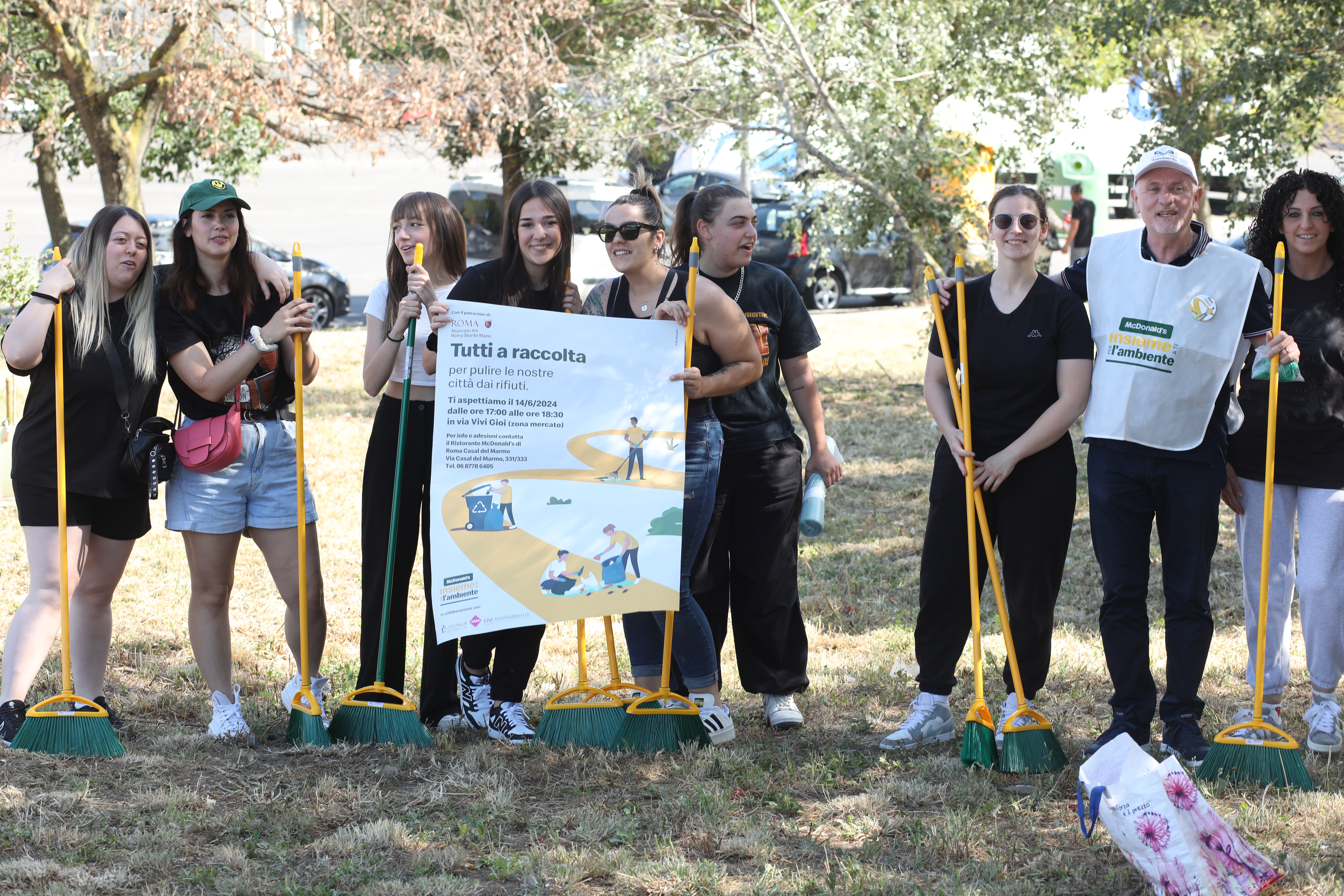 Domenico participating in a community clean- up with team members 