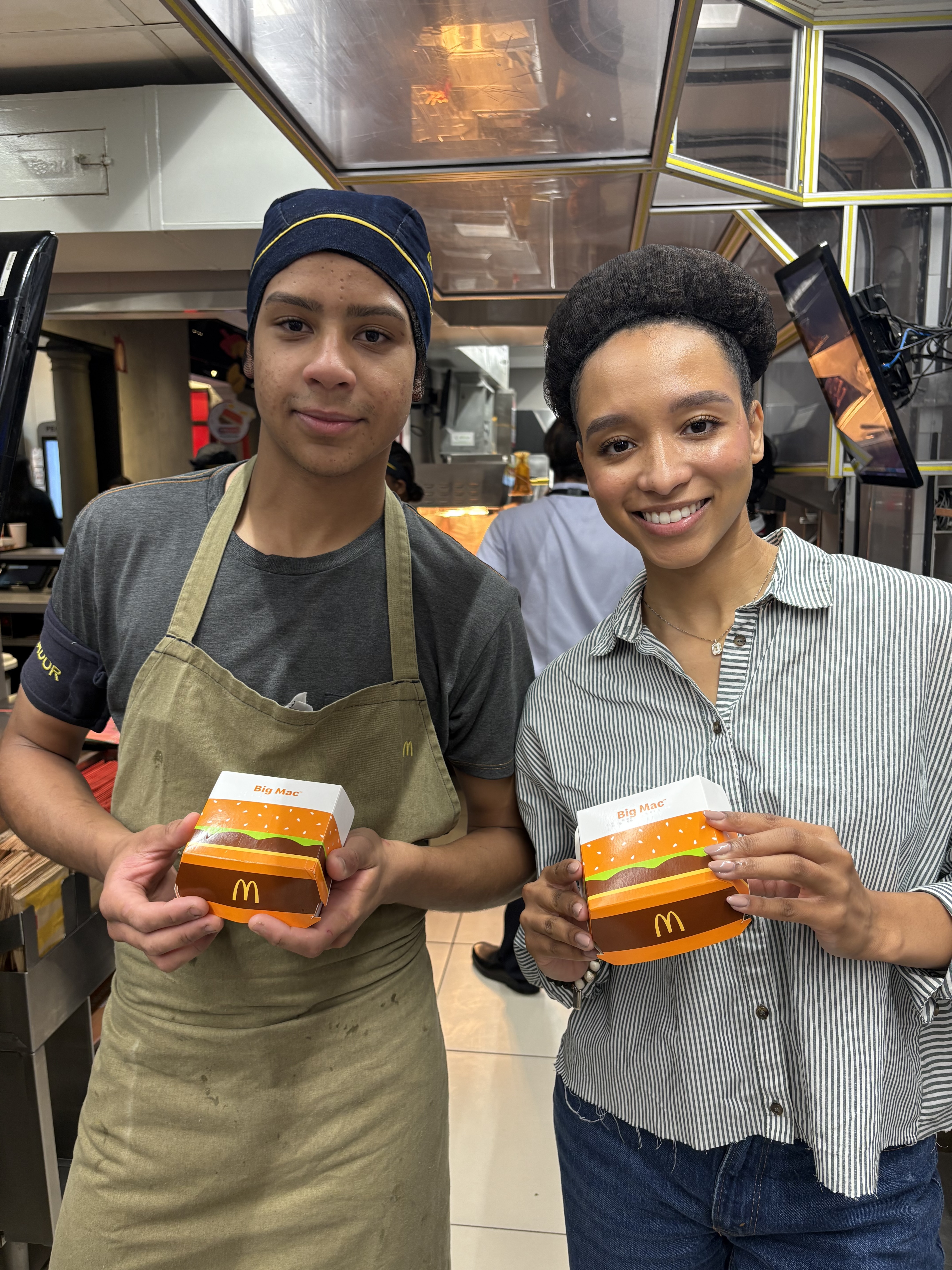 McDonald’s Latin America Crew member and Open Doors program guest posing with Big Mac containers 