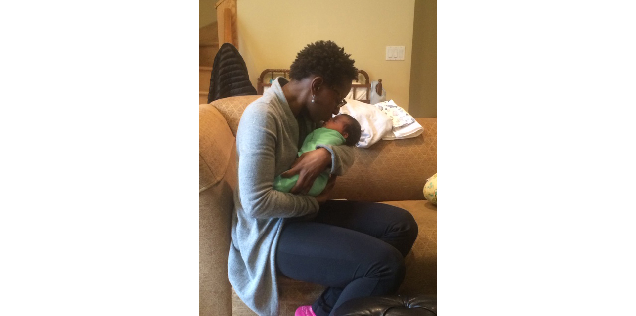 Natasha holding Avery as a baby.