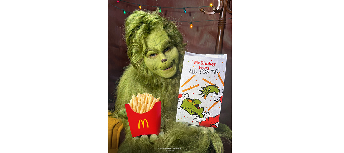 The Grinch holding french fries and meal bag 