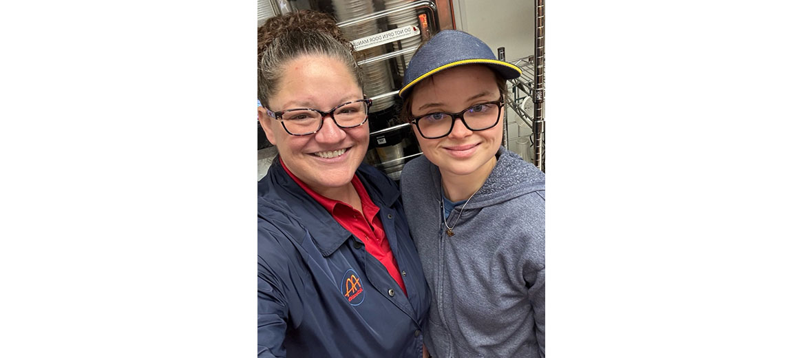 Heather Harvey takes a selfie with a team member