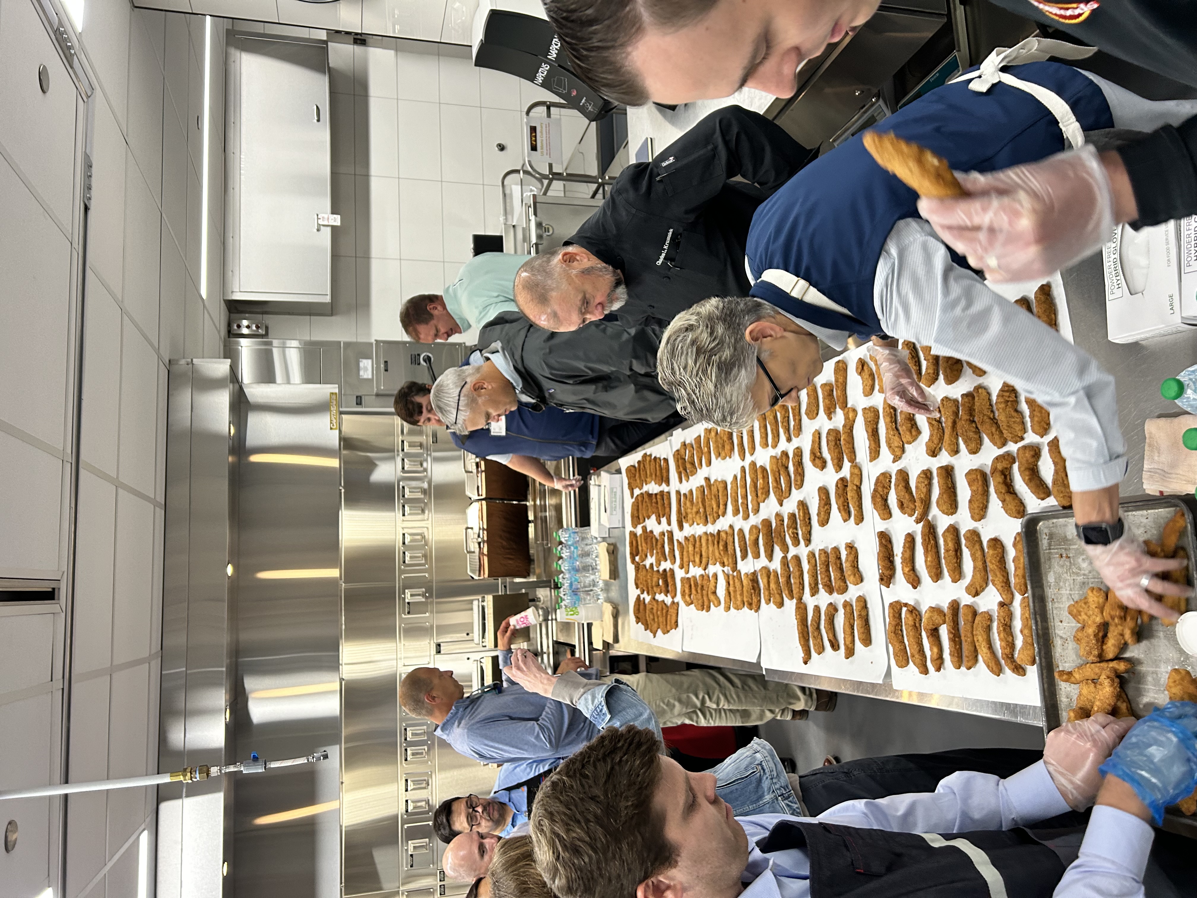 Group of Chef's cooking in front of a table 