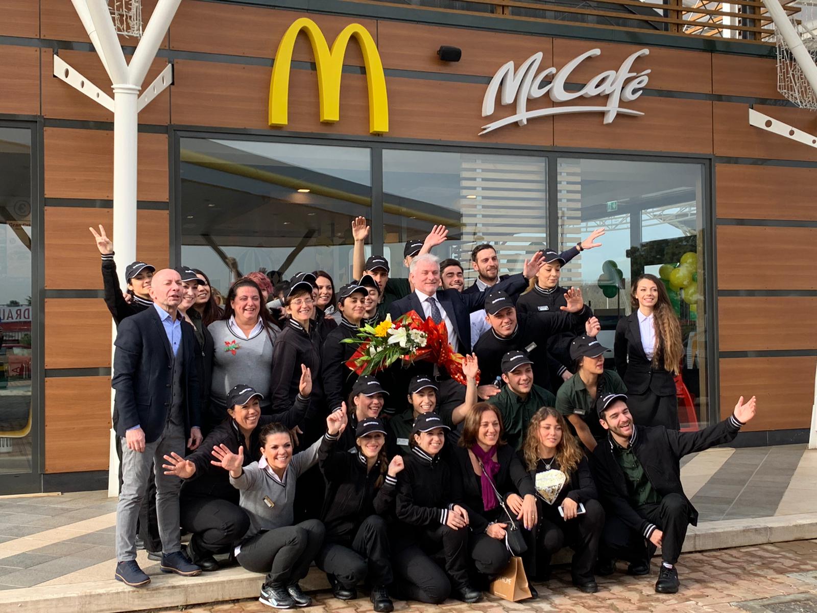 Domenico with his team posing in front of a McDonald’s restaurant Domenico with his team posing in front of a McDonald’s restaurant