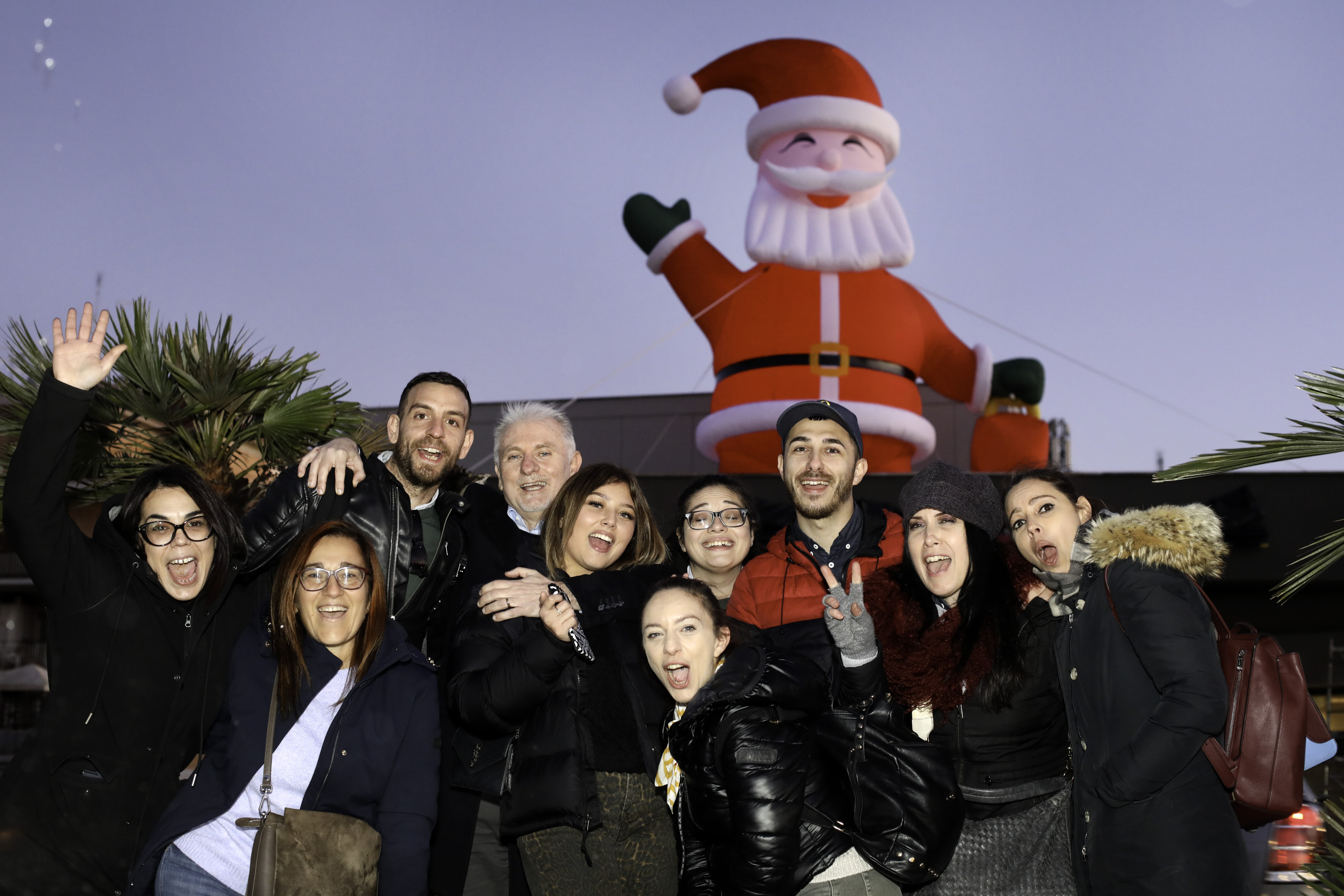 Domenico alongside community members in front of a large inflatable Santa above a McDonald’s restaurant Domenico alongside community members in front of a large inflatable Santa above a McDonald’s restaurant