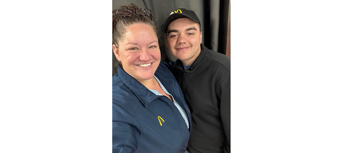 Heather Harvey smiles alongside another team member 