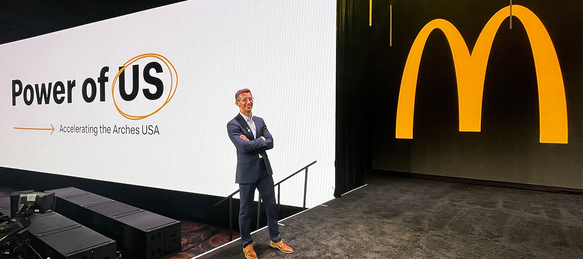 Will posing in front of McDonald's arches