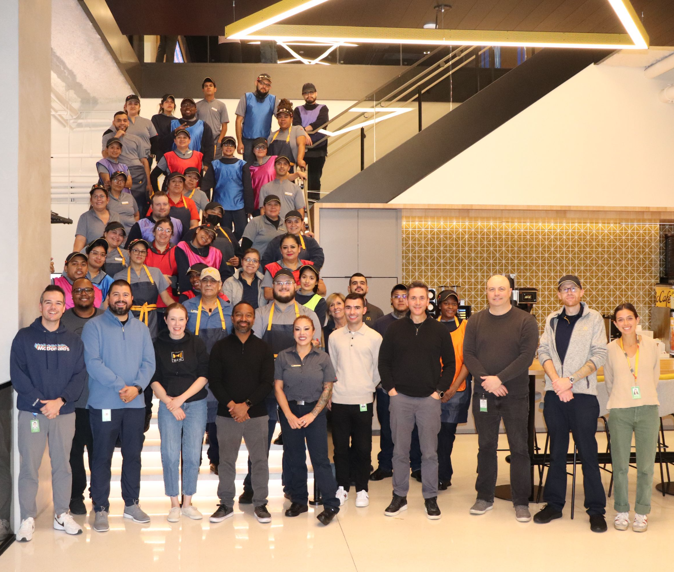 Jacques Mignault, McDonald’s SVP, Global Chief Restaurant Officer, and a group of around 60 team members inside of Speedee Labs 