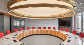 Empty conference room with red chairs fanned out in a circle
